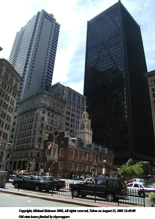 Old state house flanked by skyscrappers
