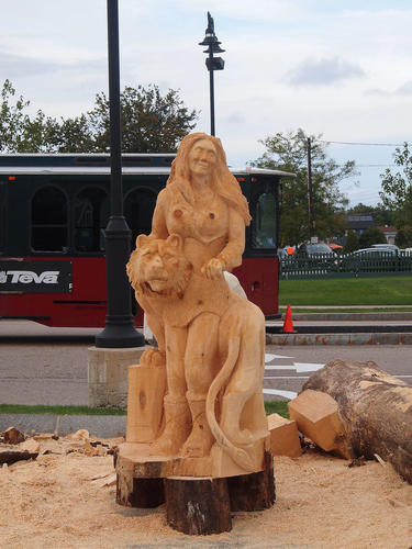 Woman with tiger wood sculpture