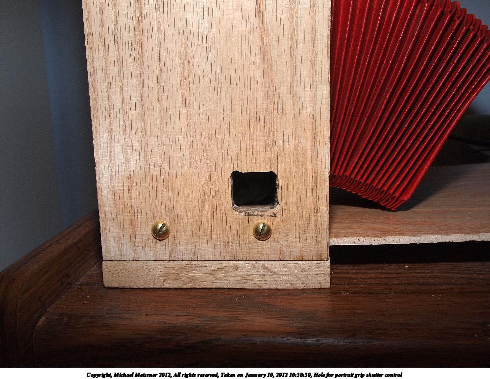 Hole for portrait grip shutter control