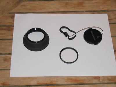 49mm lens hood, 49mm UV filter, 49mm cap with lens leash
