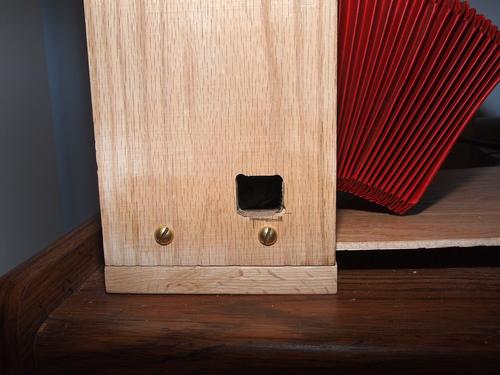 Hole for portrait grip shutter control