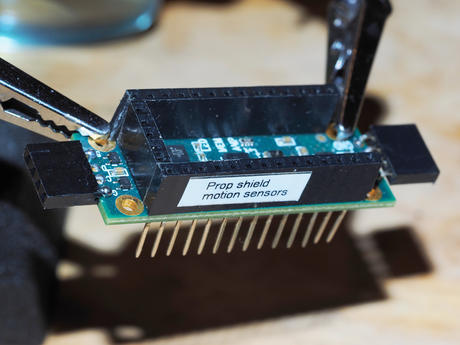 Motion sensor prop shield with stacking headers