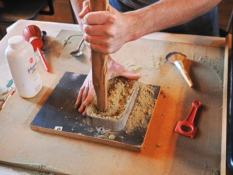 Casting metal using sand